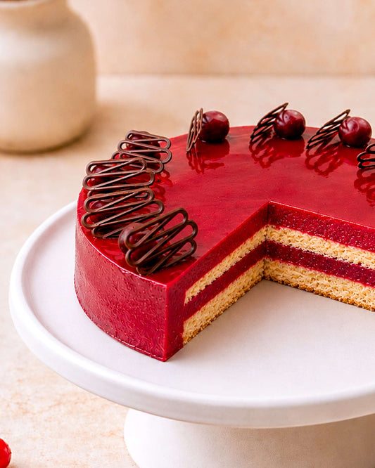 Delicious cassis mousse cake featuring layers of smooth mousse and elegant chocolate decorations.