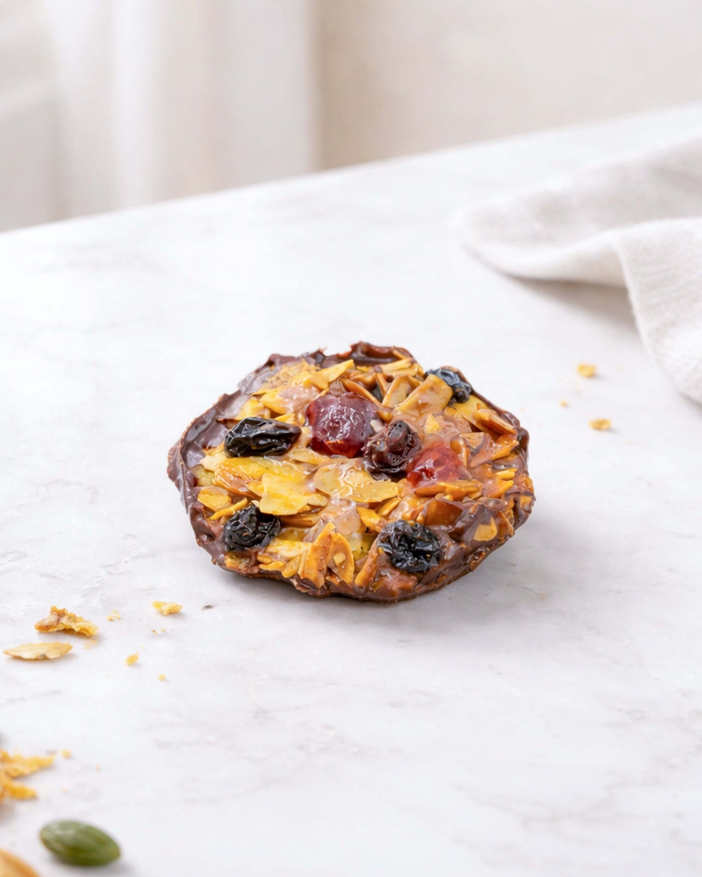 Florentine Small cookie on a marble surface with nuts and dried fruits, showcasing its crisp and nutty texture.