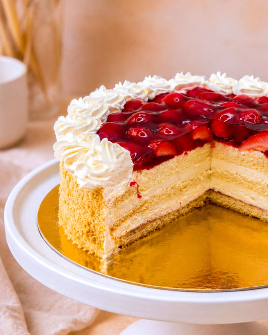 Delicious strawberry gateau with soft sponge, light cream, and fresh strawberries on top.