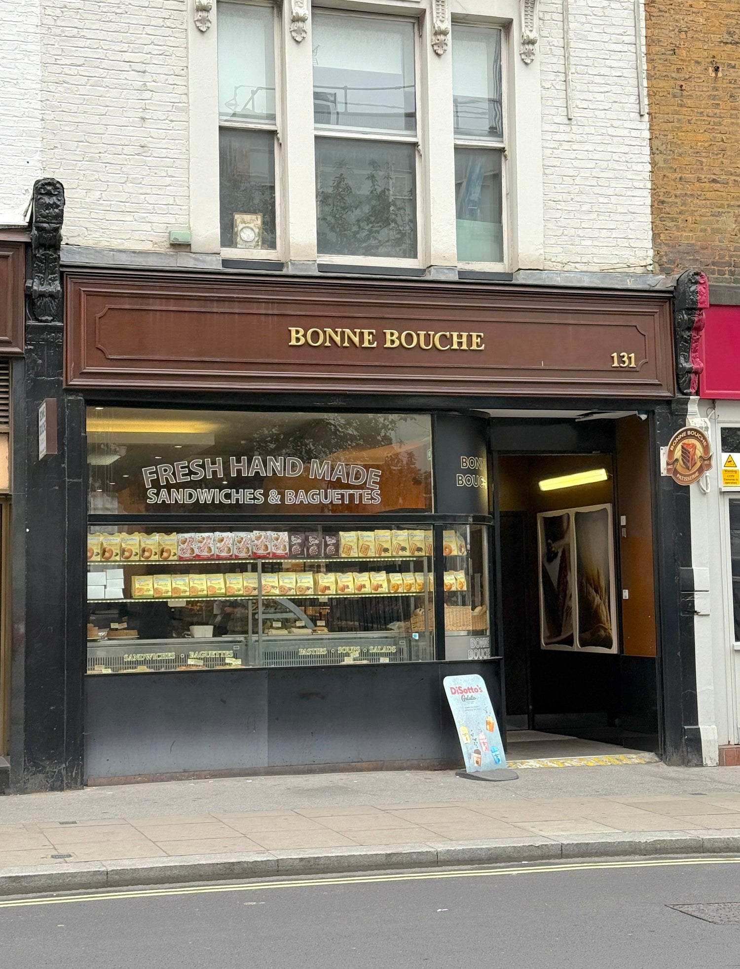 Storefront with 'Bonne Bouche' sign on a city street
